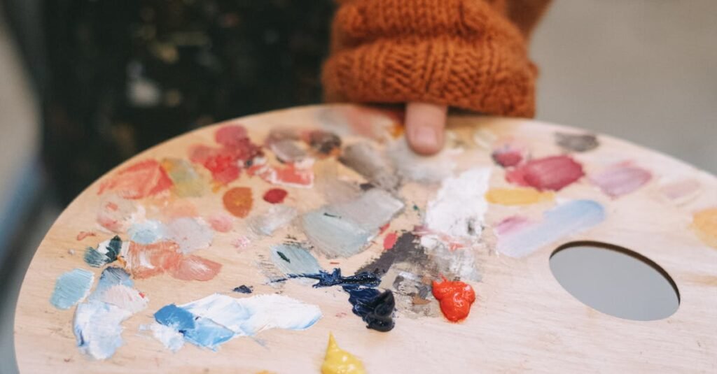 pexels-photo-6816527-6816527 A child in a cozy sweater holding a colorful paint palette during art class.